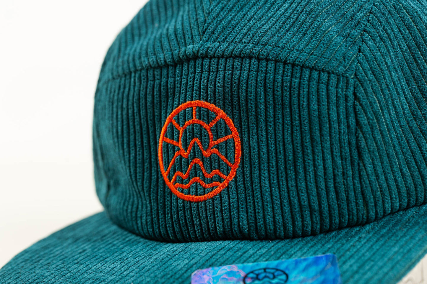 Orange McClumsy logo embroidered on a Rich Green Corduroy 5 Panel McClumsy Hat Close Close