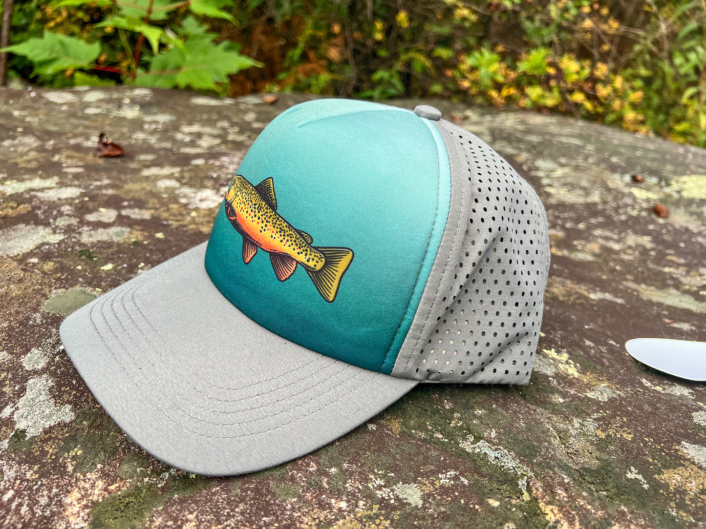 McClumsy Brown Trout Hat Profile Outside on a rock in nature