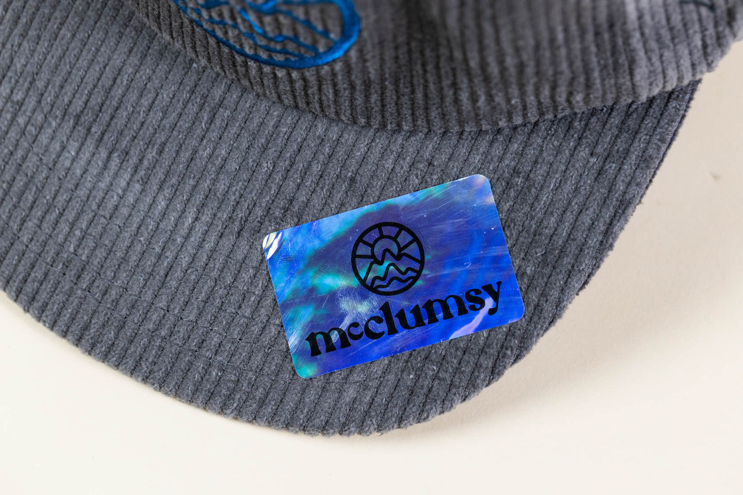 McClumsy Corduroy Camper Hat Blue on Gray Upper Brim With Sticker Close Up