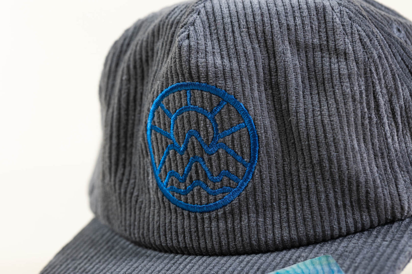 McClumsy Corduroy Camper Hat Blue on Gray Front Close up Logo
