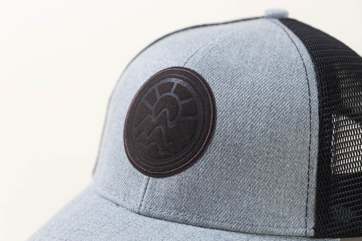 McClumsy Hat Brown Suede Logo on Gray Black Logo Closeup