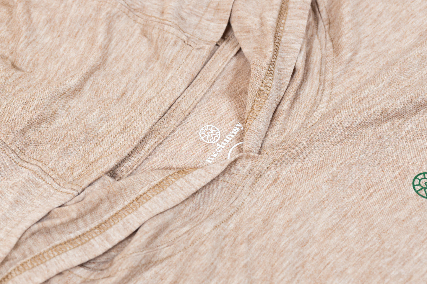 McClumsy Lightweight Hoodie Tan Heather Tag Logo Close