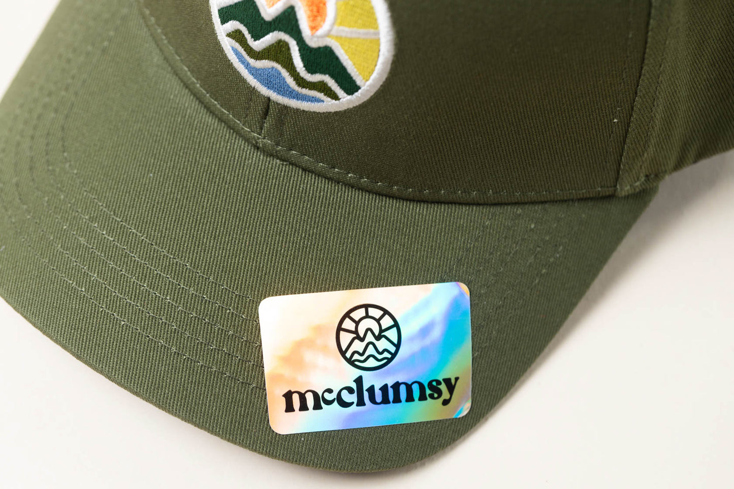 McClumsy Hat Full Color Logo on Forest Service Green Bill and Sticker