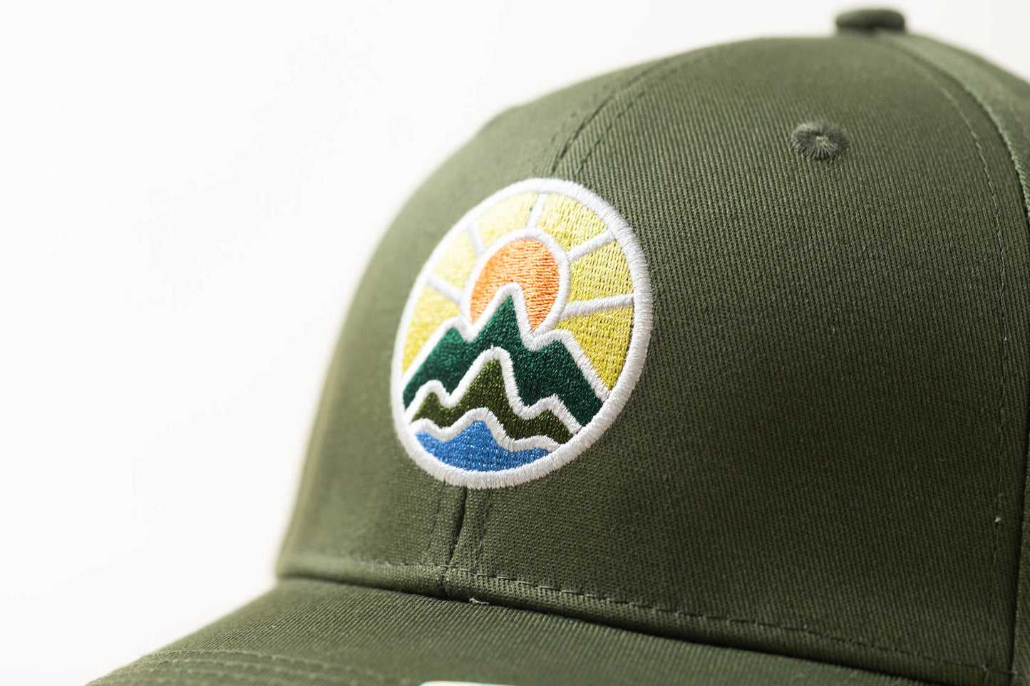 McClumsy Hat Full Color Logo on Forest Service Green Logo Close