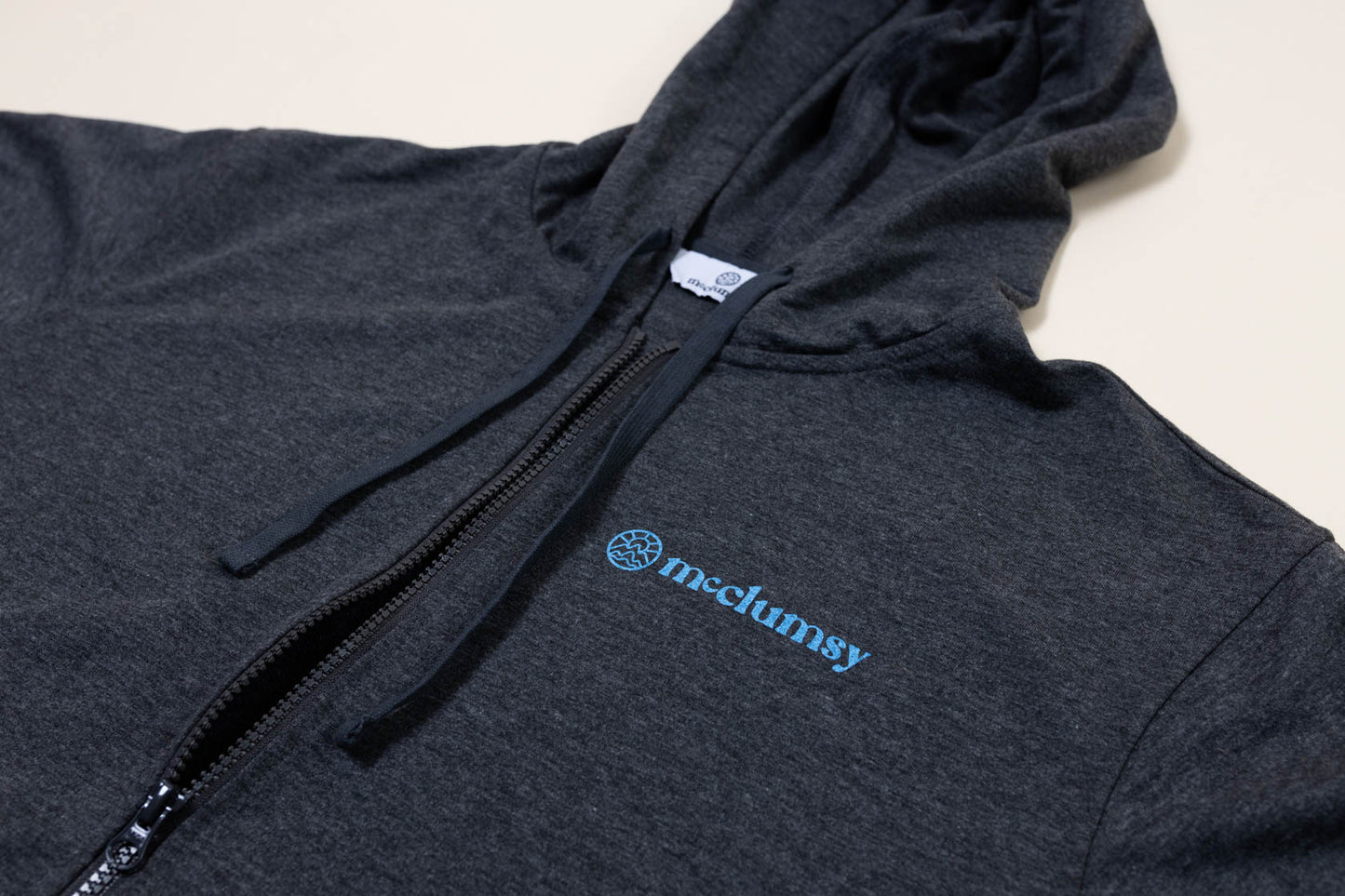 McClumsy McLogo Zip Hoodie Light Blue on Dark Grey-Front Close Up with Logo and Hood