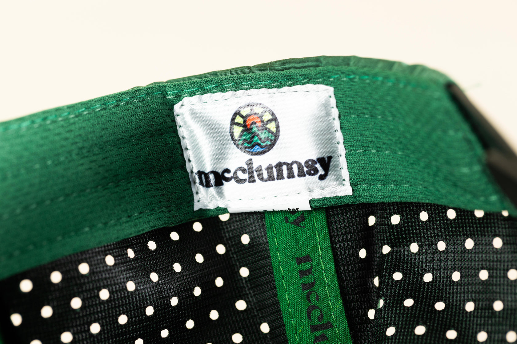 McClumsy Label on the inside sweatband of the Green McClumsy 7-Panel Laser Cut Back Trucker Hat. 